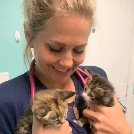 Dr. Griffen holding two kittens